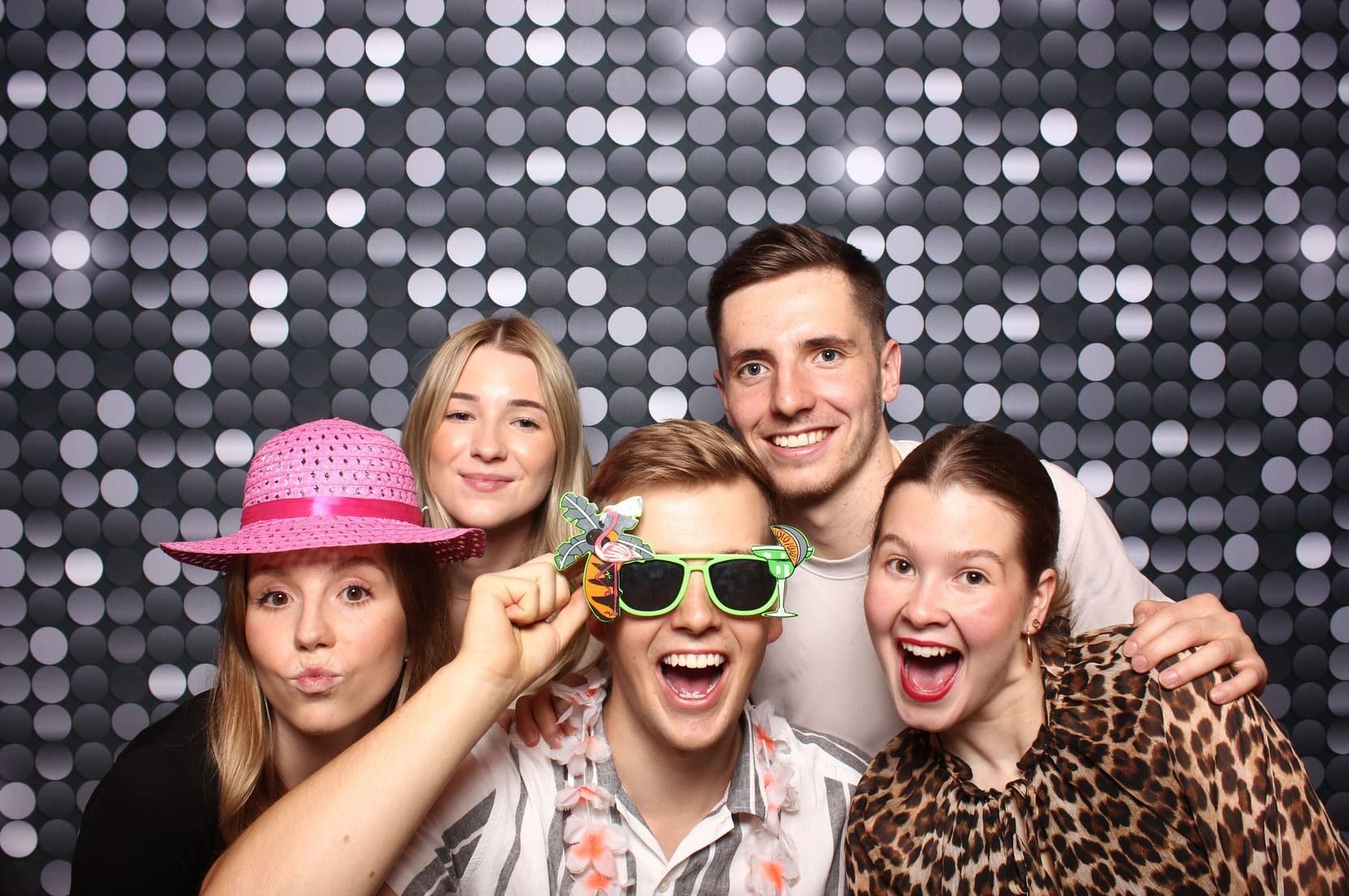 Junge Leute machen lustiges Foto auf einem Geburtstag in der Fotobox